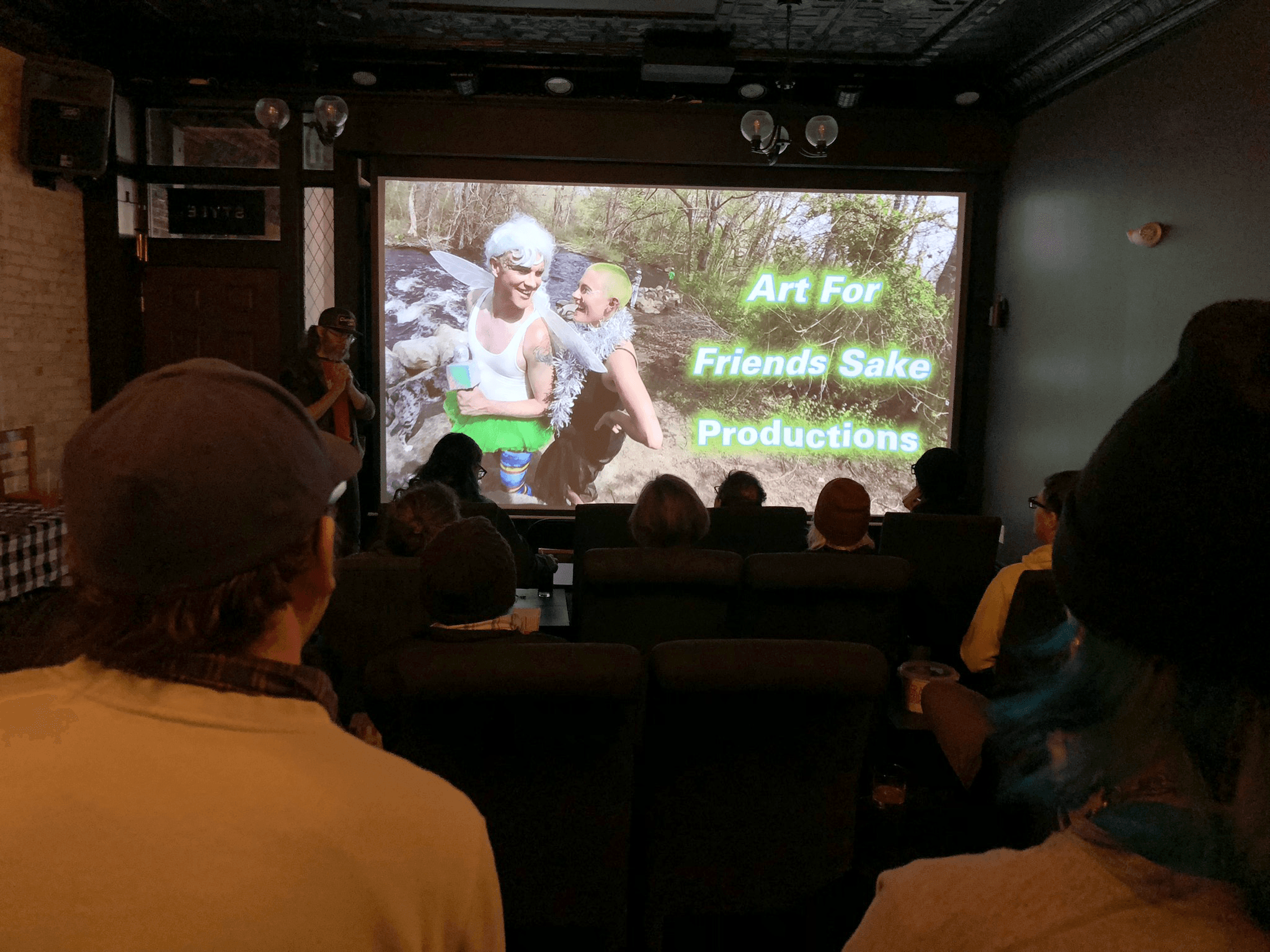 A packed Cinema 514 audience watching an Art For Friends Sake Productions screening